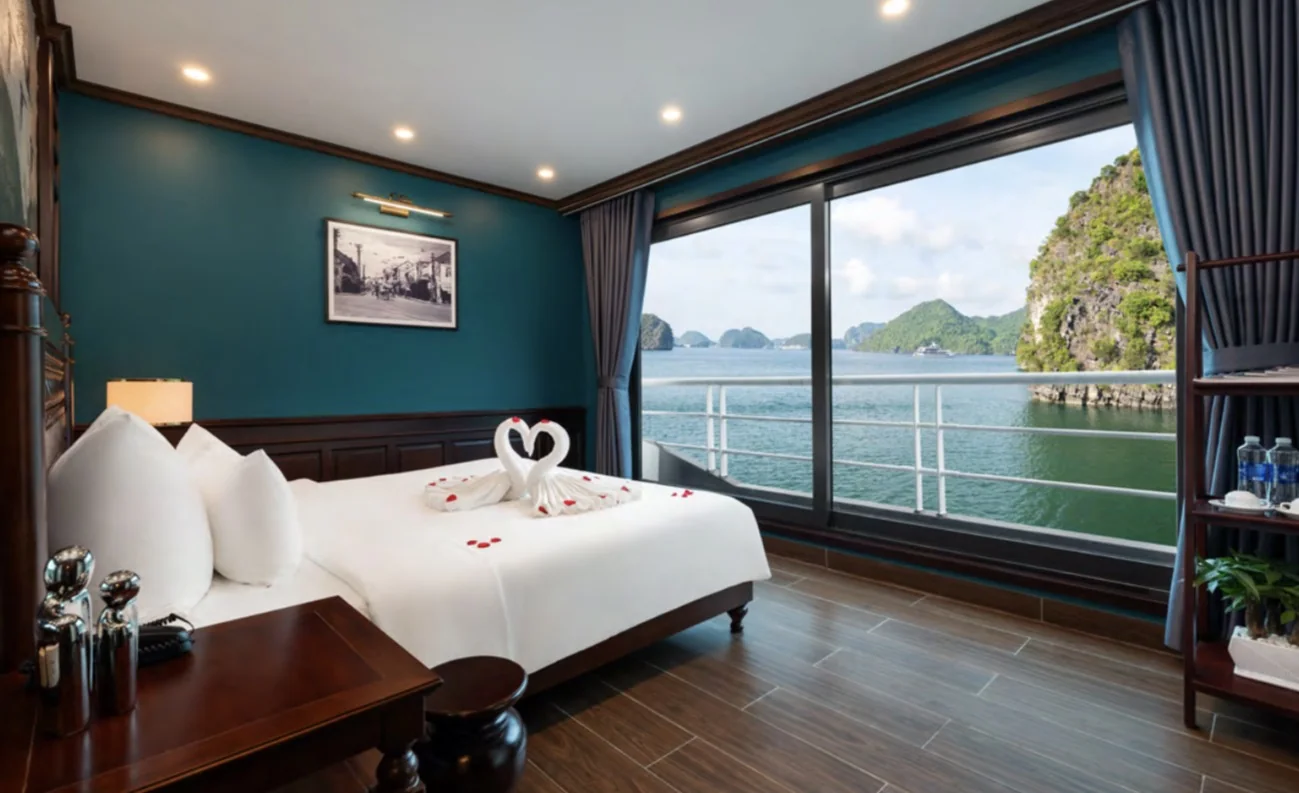 Cabin with a double bed and a window onto the bay on Lan Ha Escape Cruise